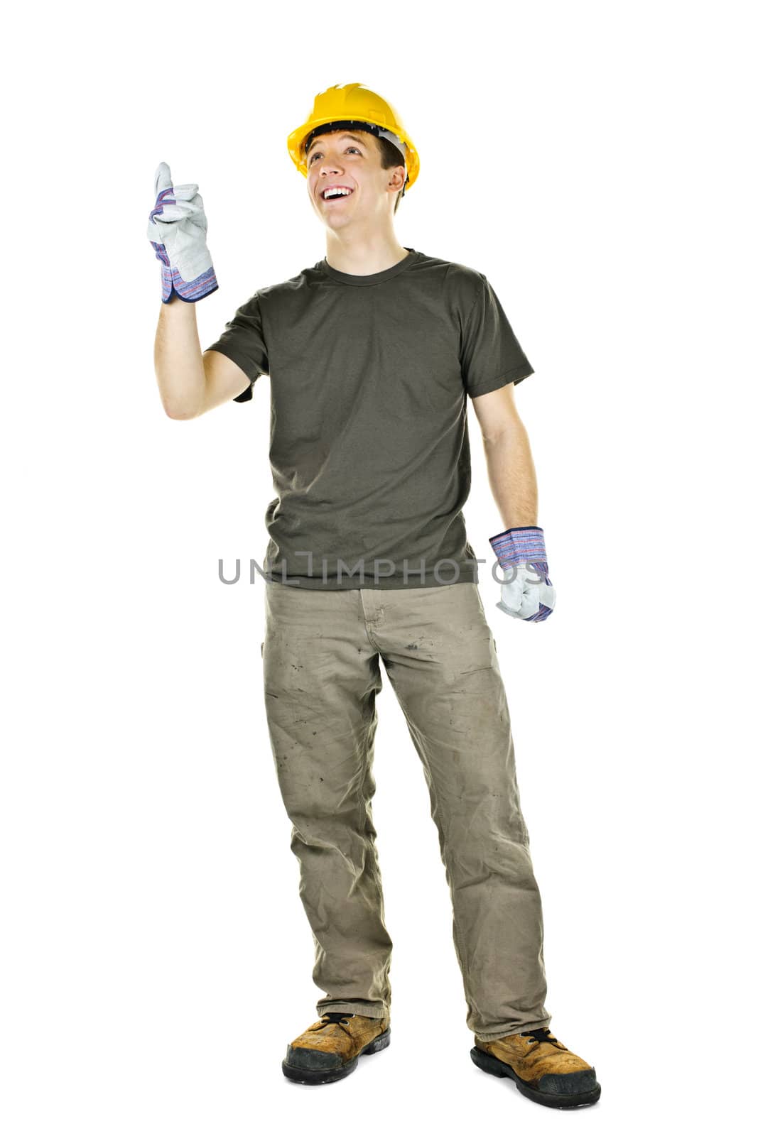 Smiling construction worker pointing up standing isolated on white background