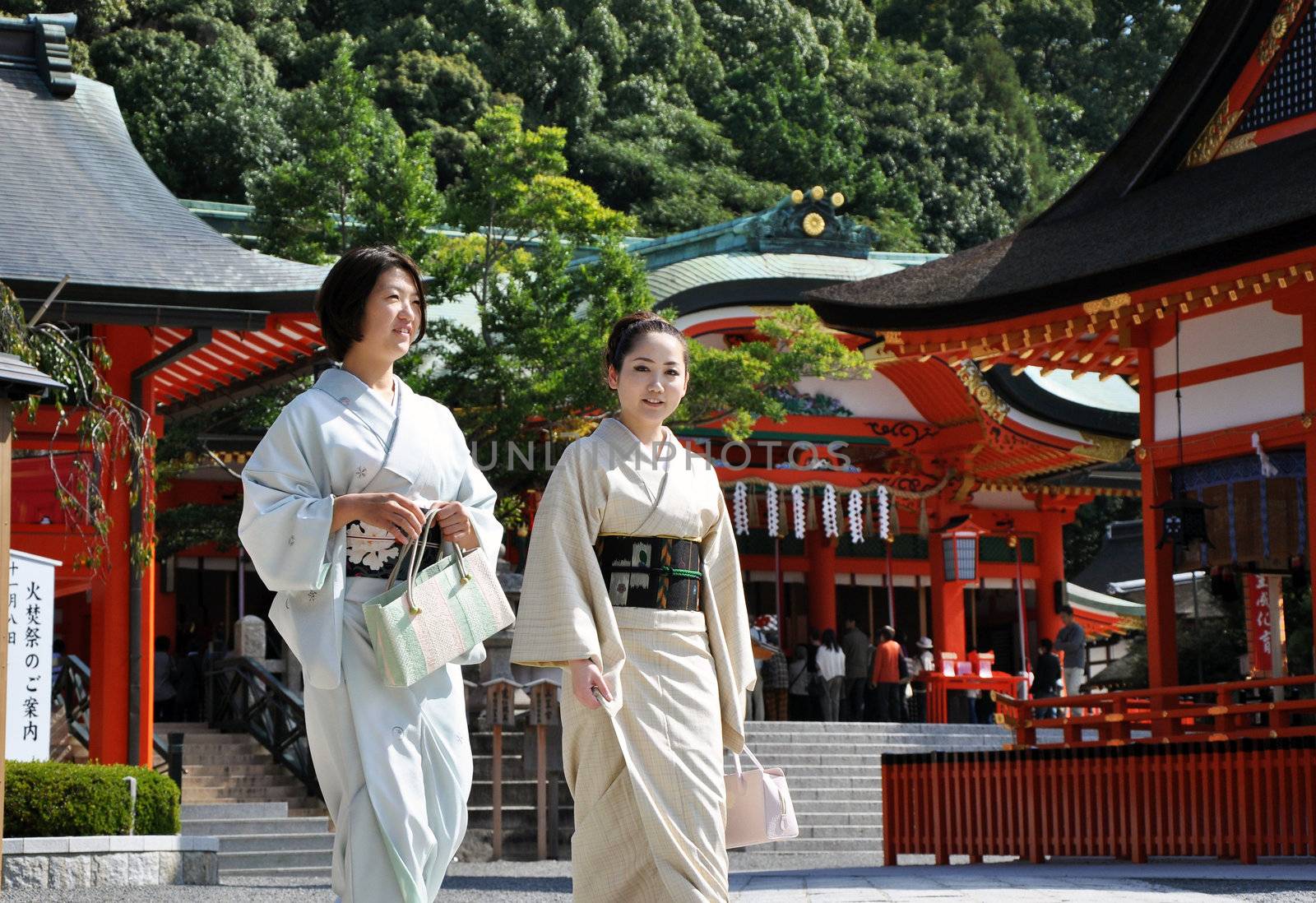 KYOTO, JAPAN - OCT 23 2012: Japanese girls at Fushimi Inari by siraanamwong