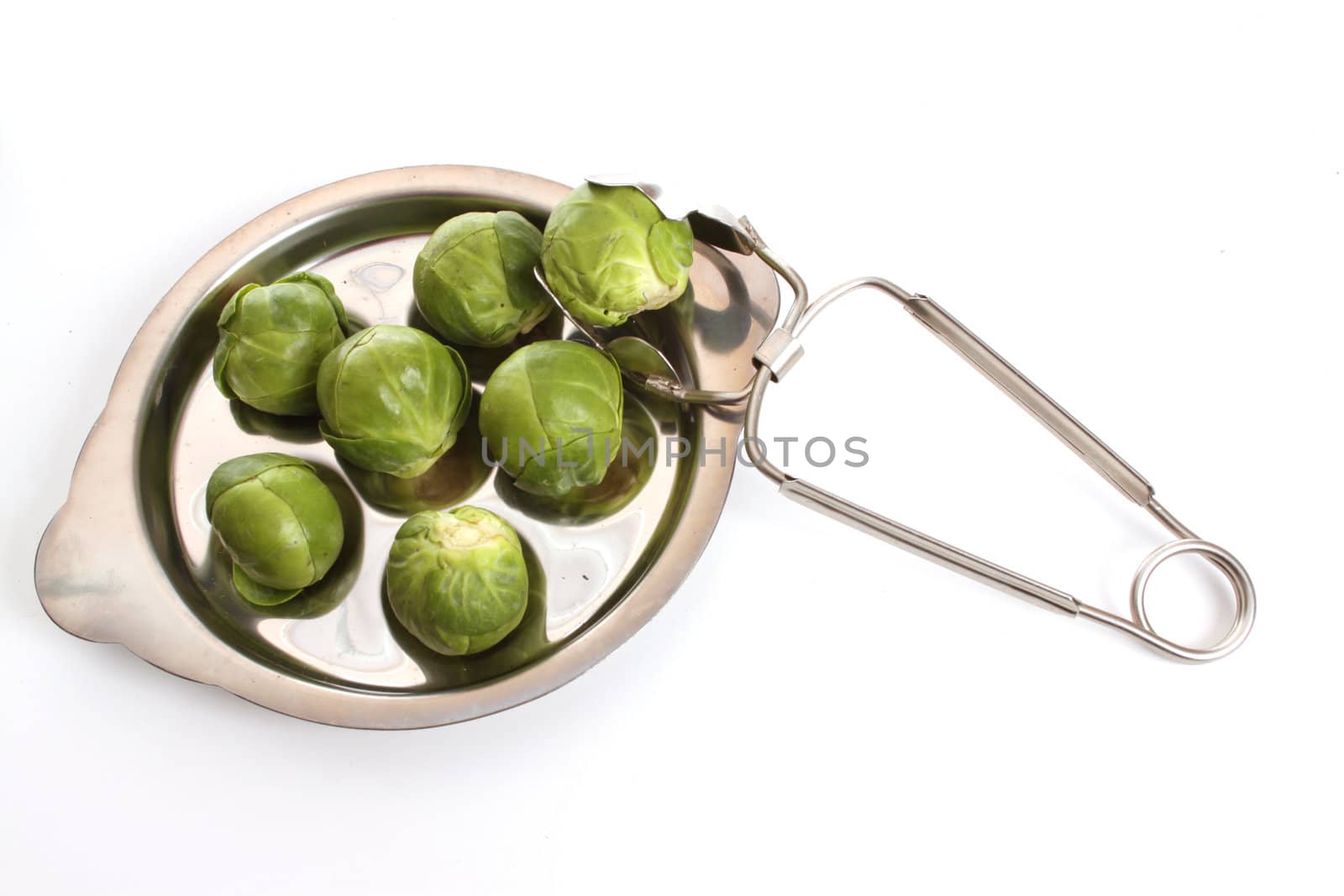 Brussels sprouts in a studio setting over white