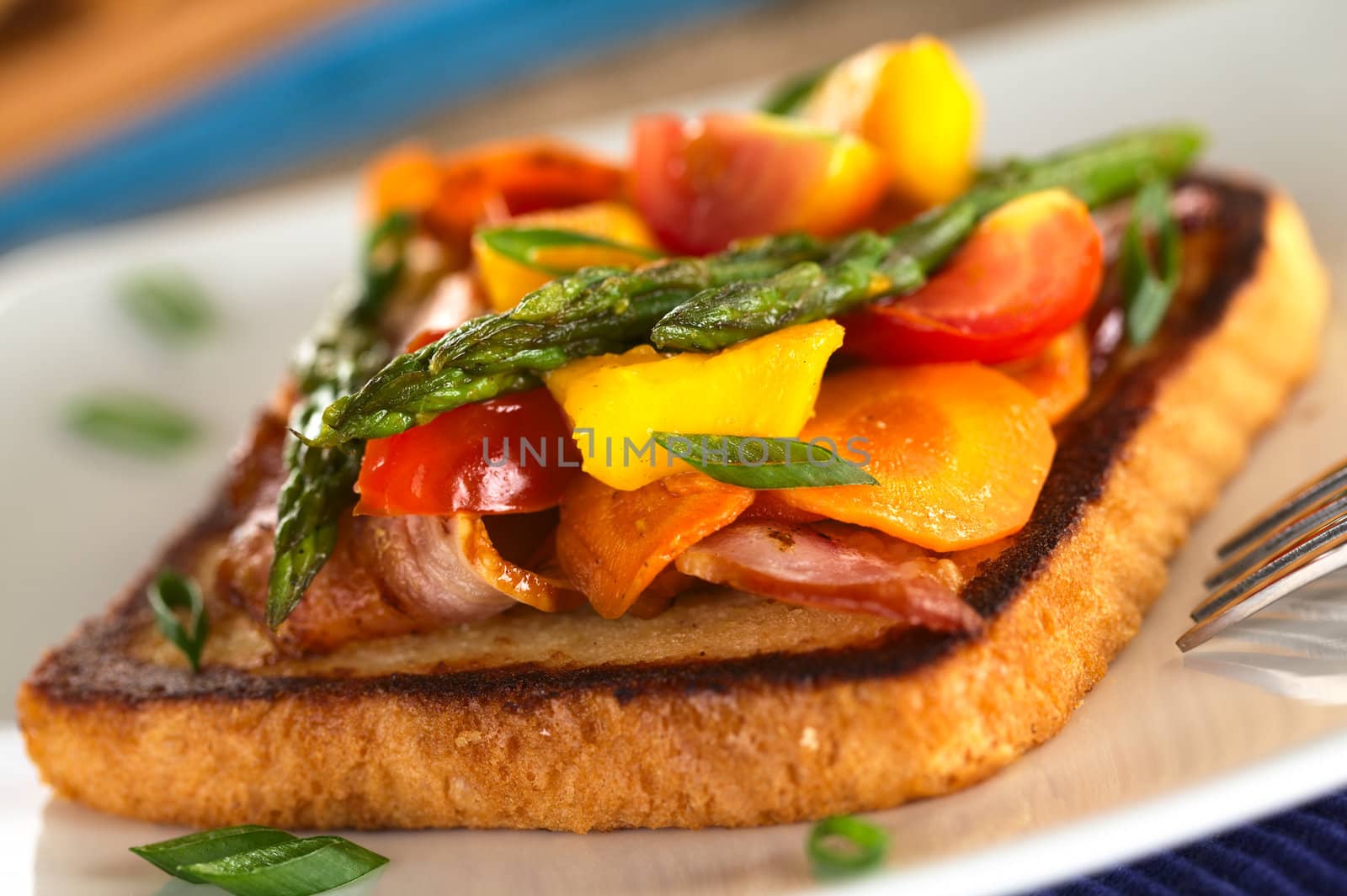 Baked asparagus, mango, tomato, carrot and bacon sandwich on wholewheat toast bread (Selective Focus, Focus on the two asparagus tips on the top)