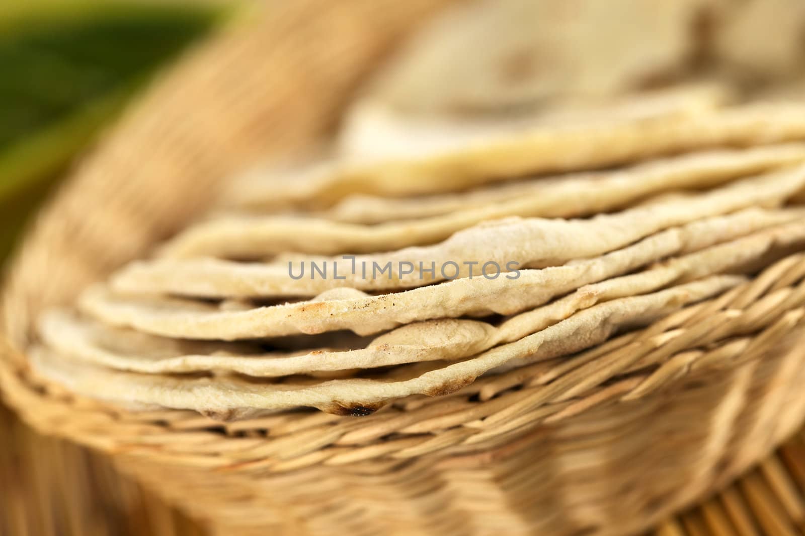 Indian flatbread called chapati in basket (Selective Focus, Focus on the front edge of the first three chapati)