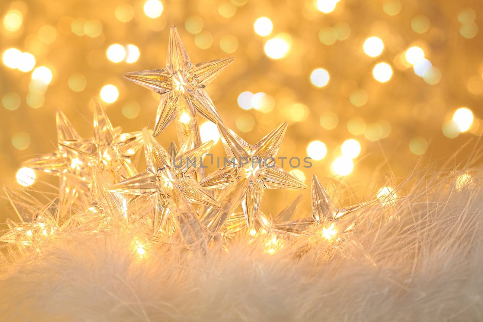 Star holiday lights with gold sparkle background