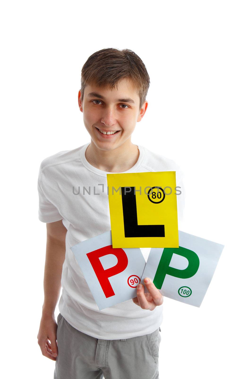 A teenage boy holding three magnetic licence plate signs for displaying on car.