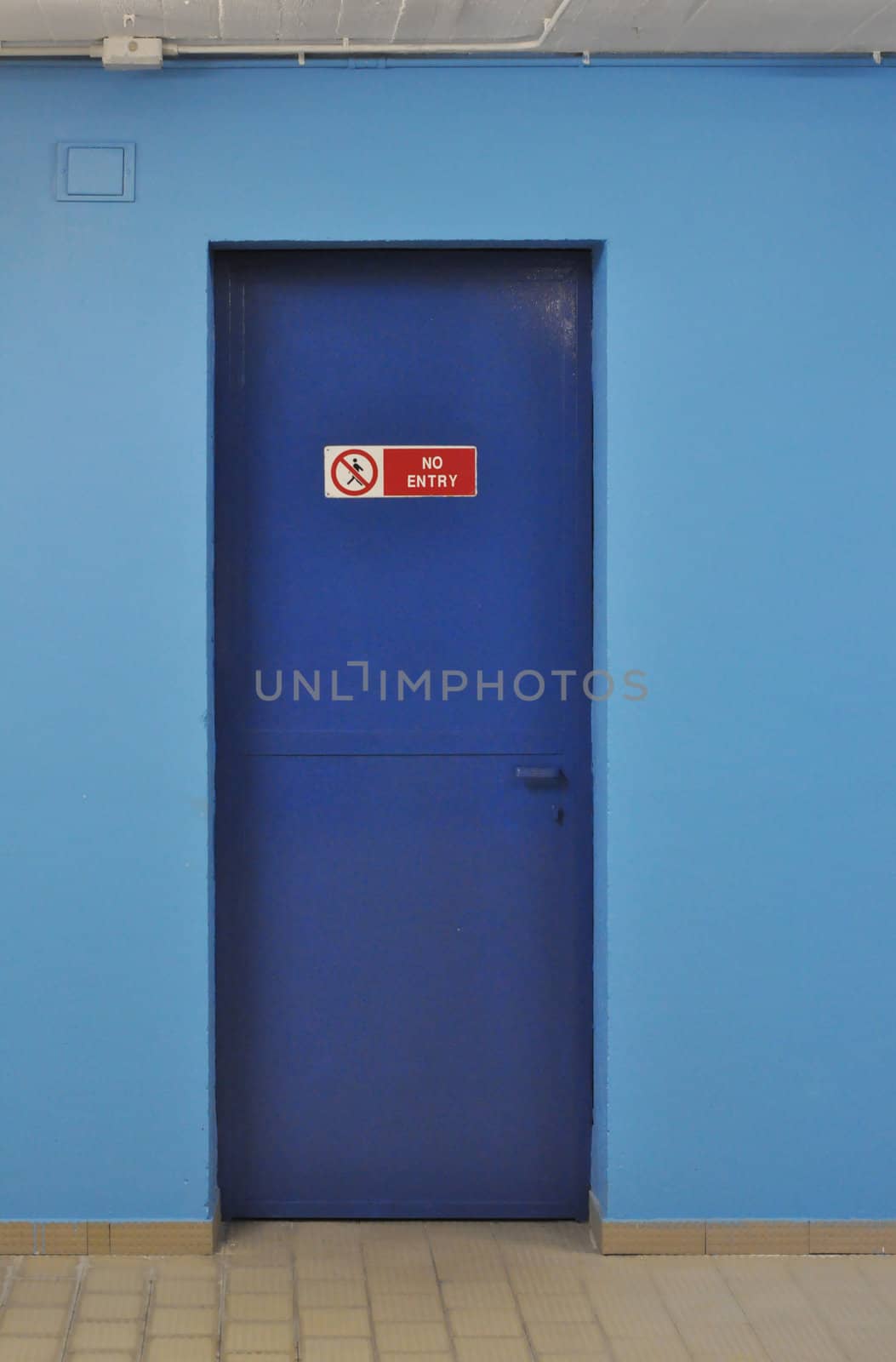 No entry sign on a blue firewall door