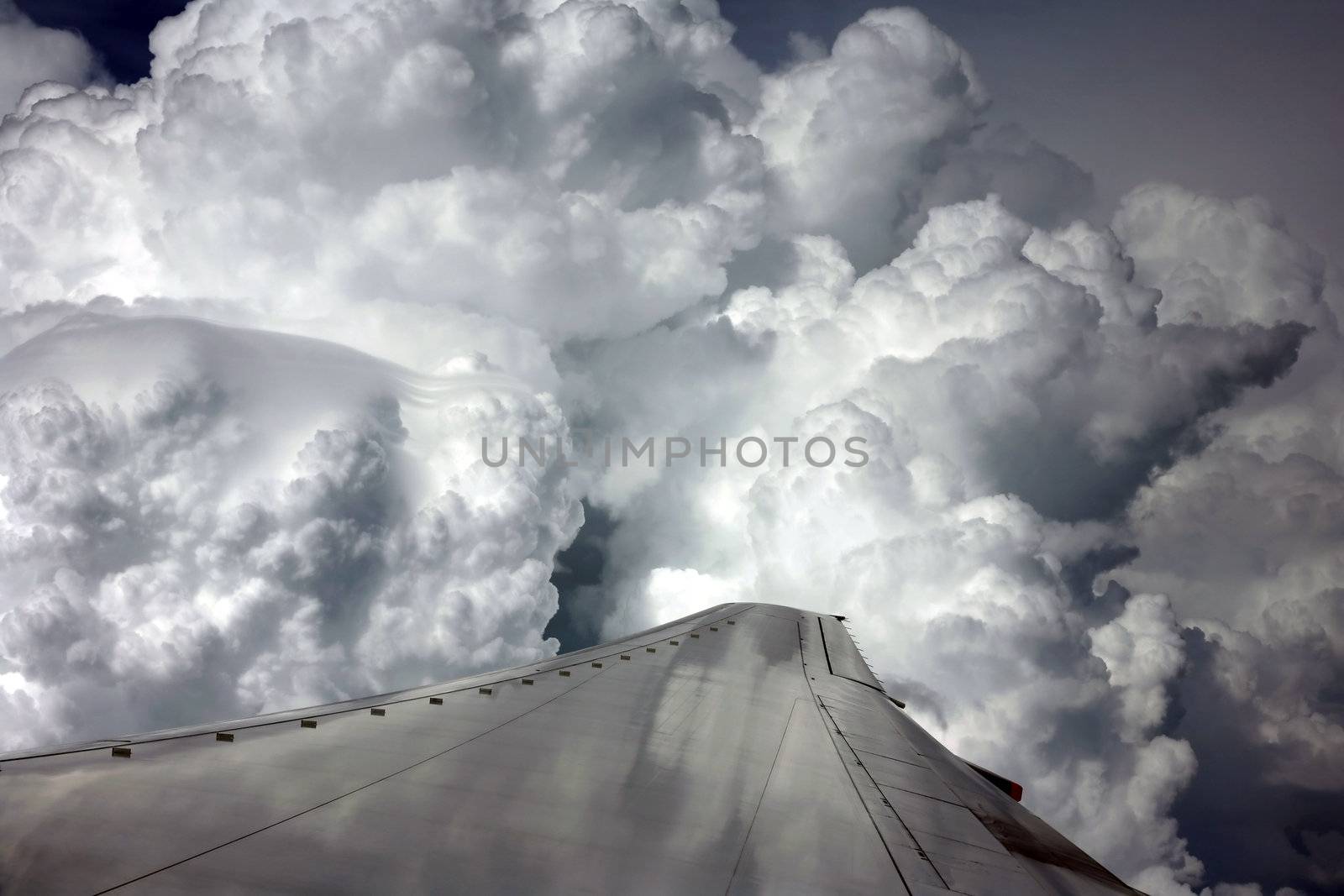 Wing of the plane on a background of clouds