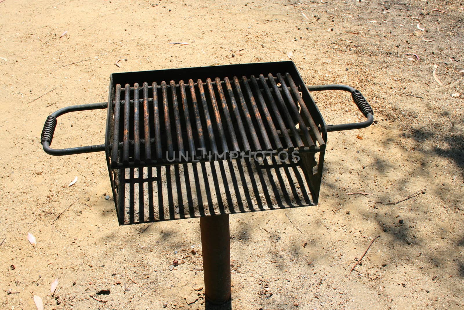 Close up of a grill in a park.
