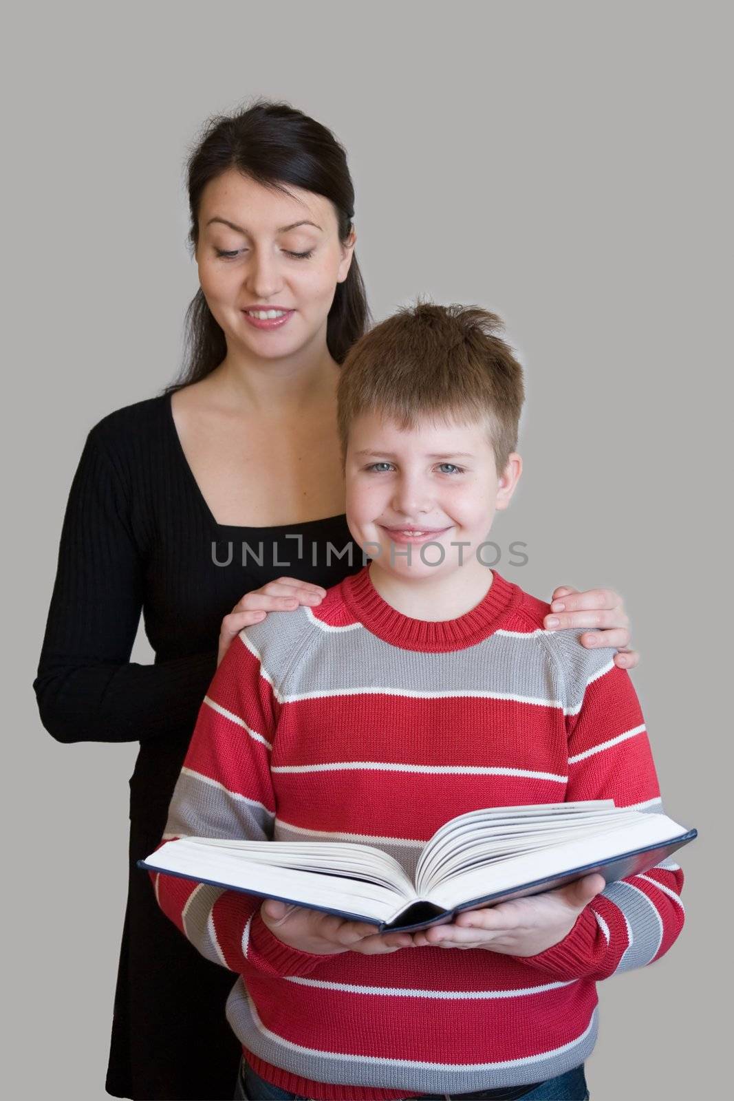 Family with book on a grey background