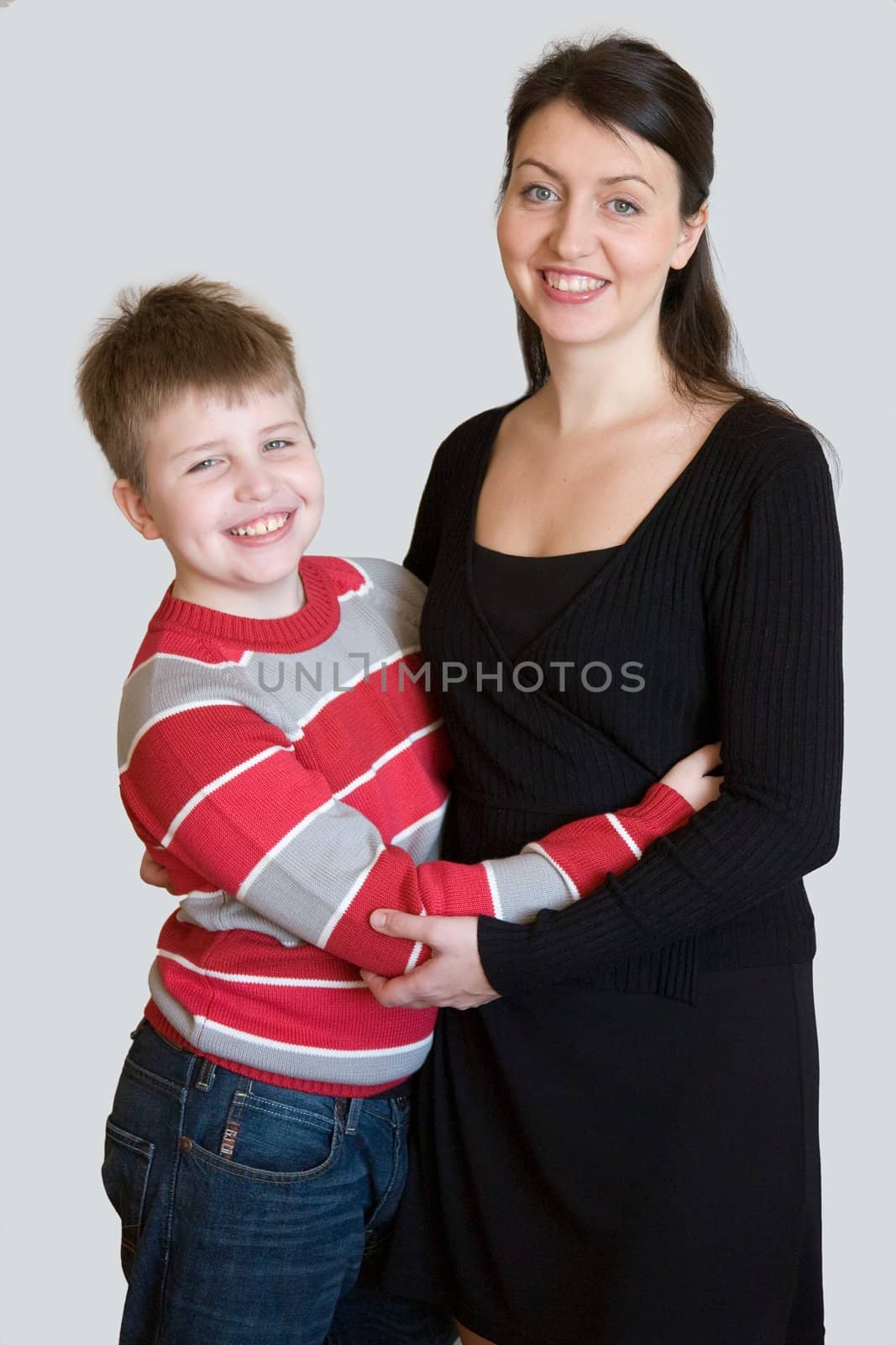 Smiling family. Mum and the son on a grey backgroun.