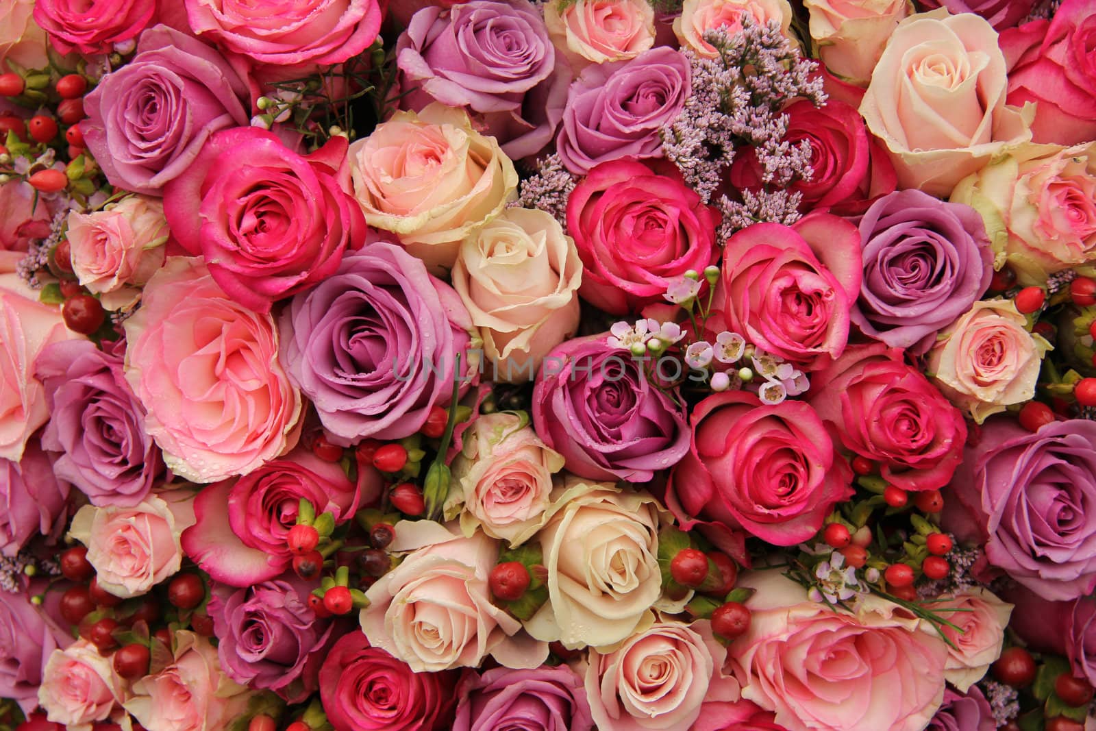 purple and pink roses wedding arrangement by studioportosabbia