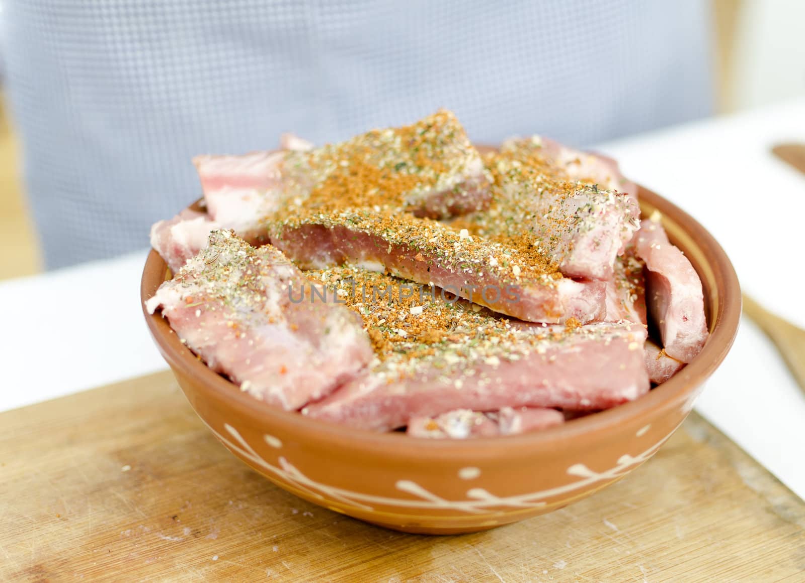 raw pork ribs with spices on a plate