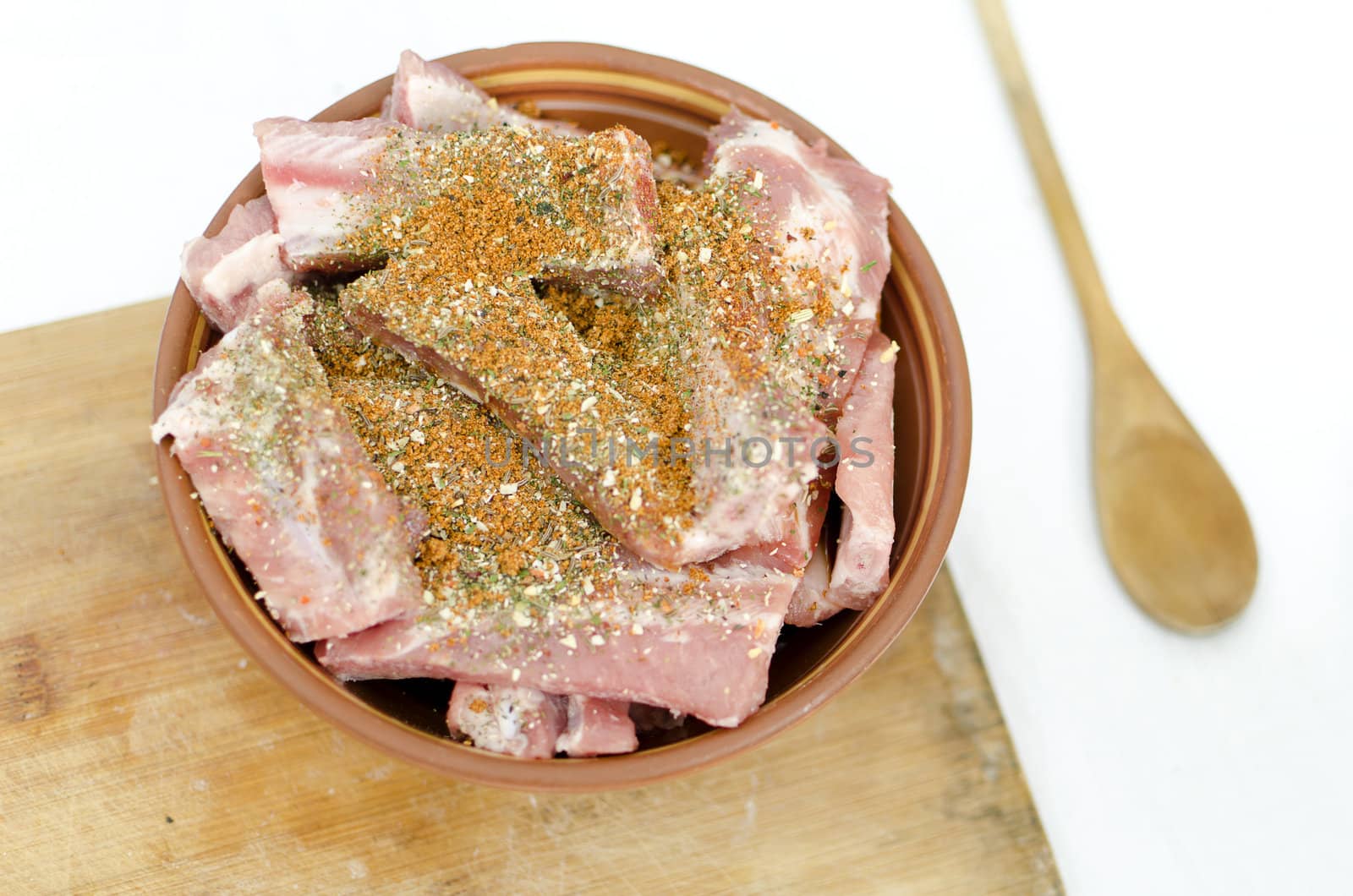 raw pork ribs with spices on a plate