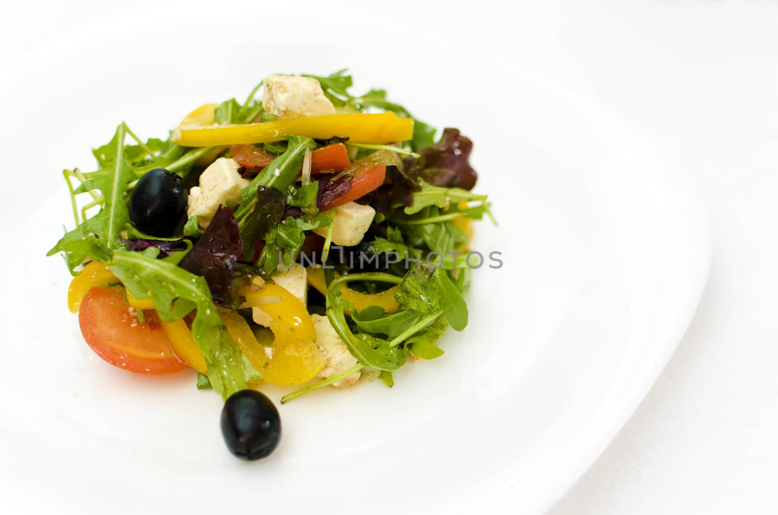 fresh Greek salad on white plate