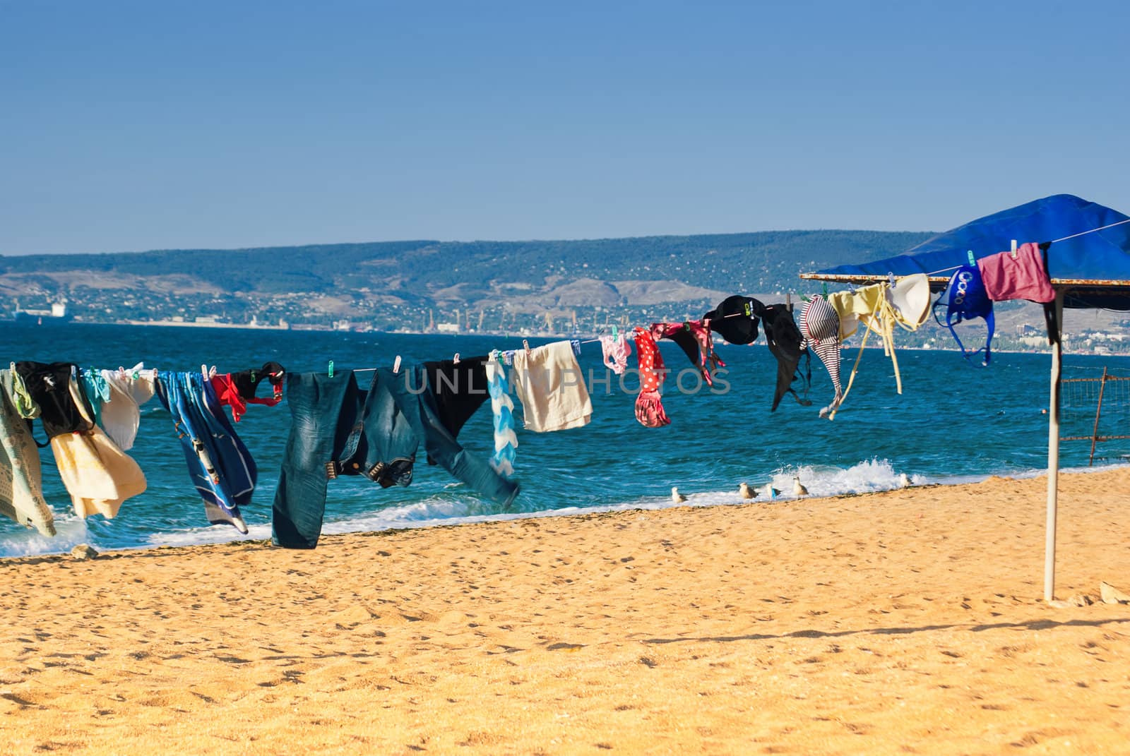 Washed clothes drying on the beach