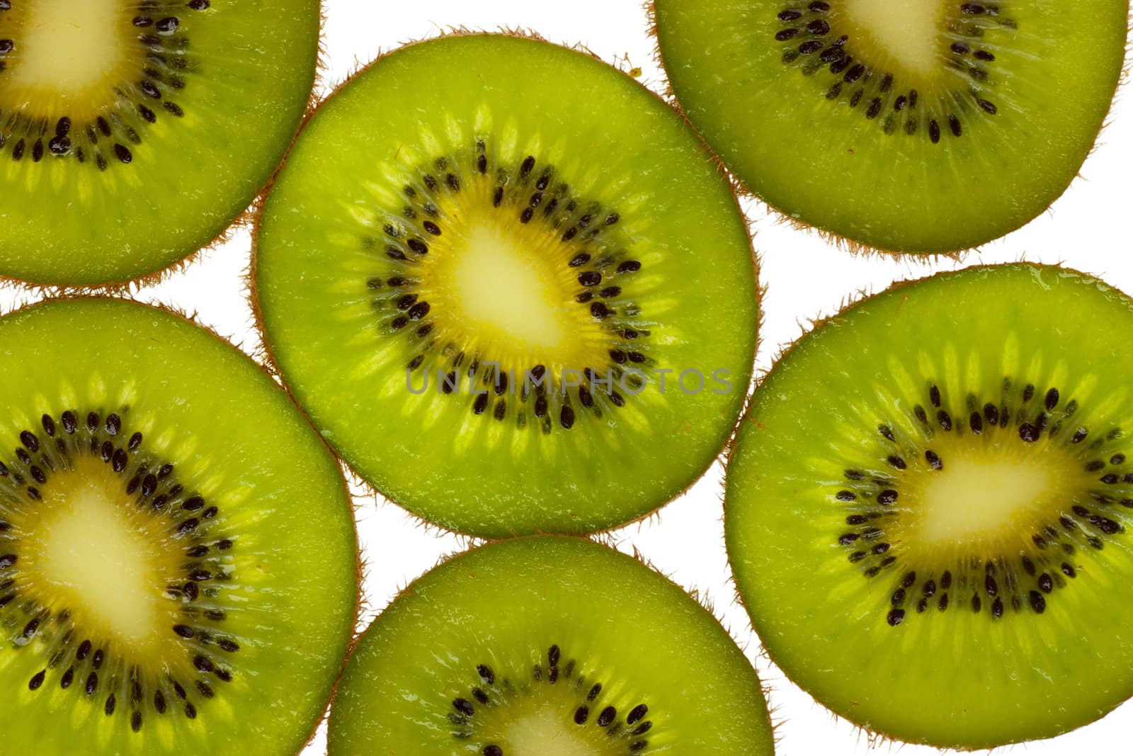 Close-up view of kiwi slices over white background