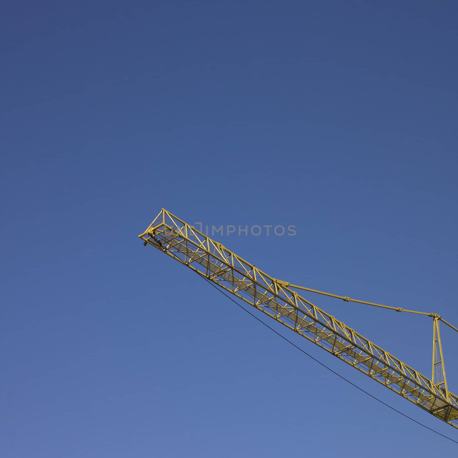 yellow construction crane and blue sky