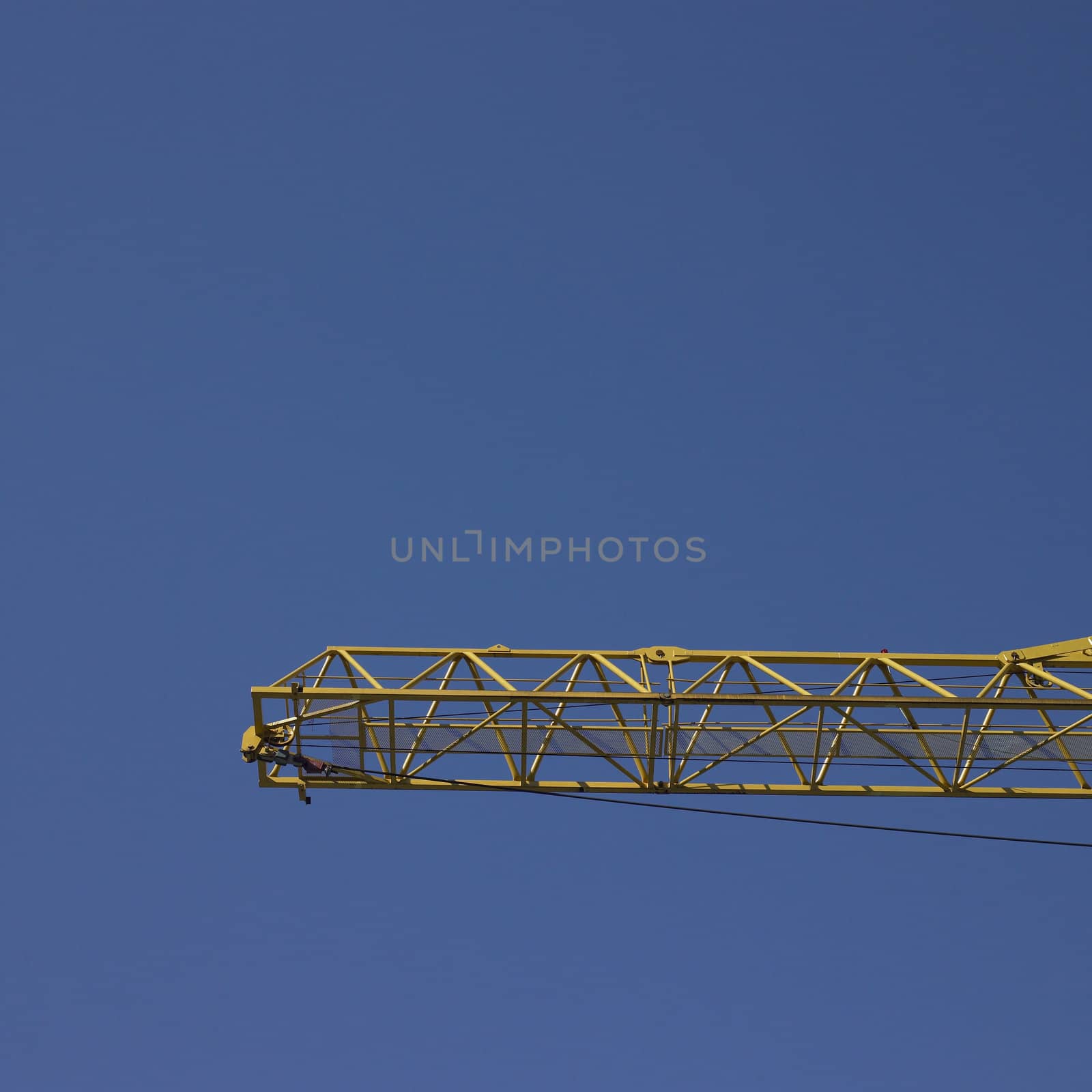 yellow construction crane and blue sky