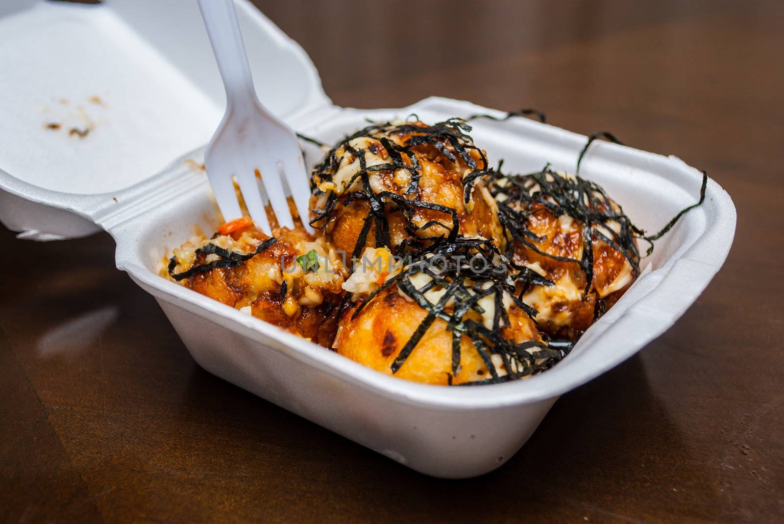 Takoyaki is a ball-shaped Japanese snack made of a wheat flour-based batter and cooked in a special takoyaki pan. It is typically filled with minced or diced octopus, tempura scraps (tenkasu), pickled ginger, and green onion. is Japanese food,  
