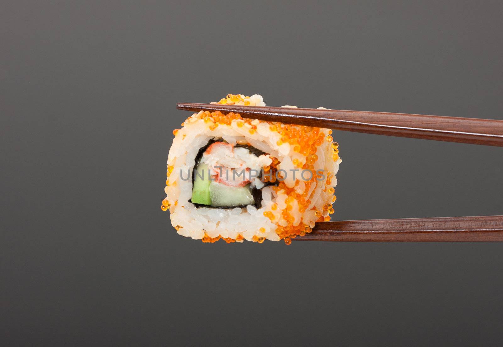 Sushi with chopsticks isolated over gray background