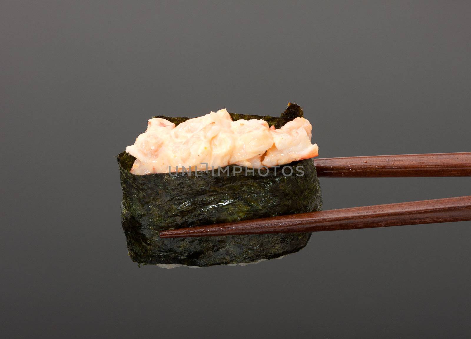 Sushi with chopsticks isolated over gray background