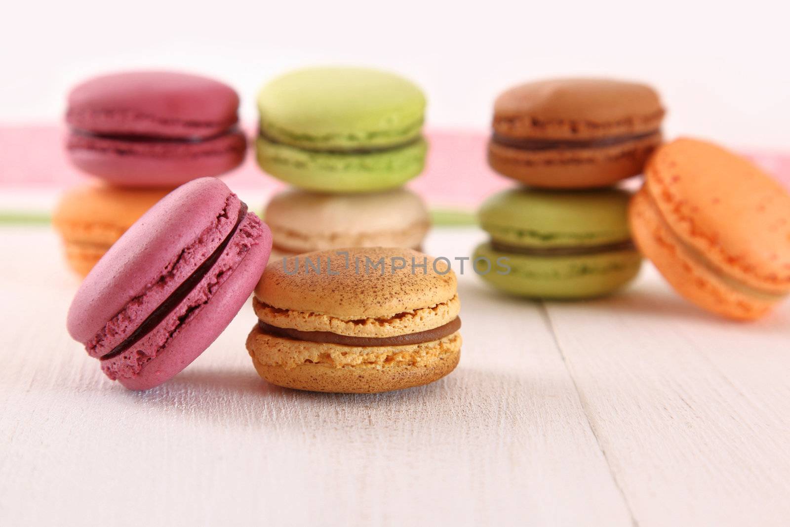 Delicious macaroons on wood table by Sandralise