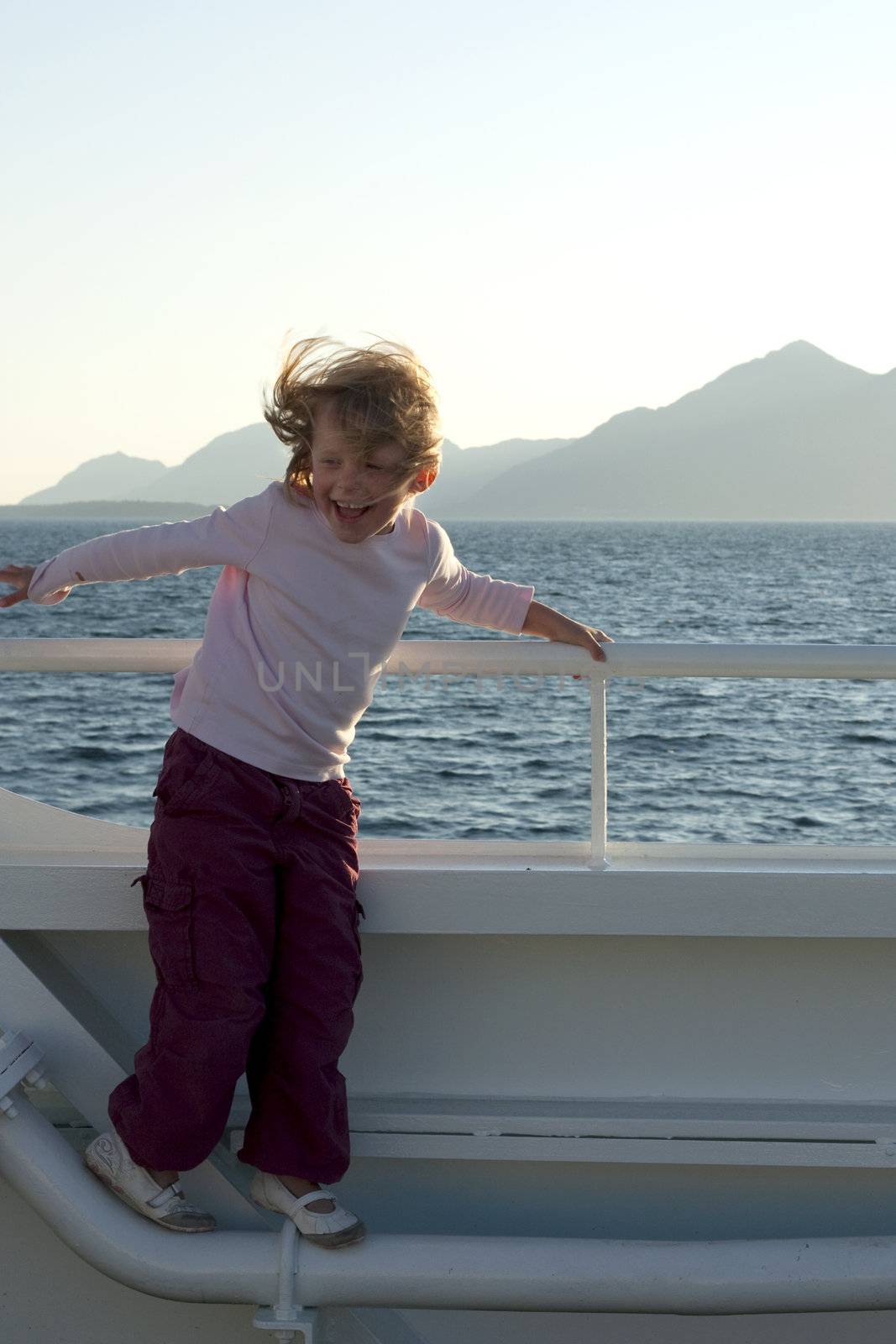 Girl laughing in the wind on a boat