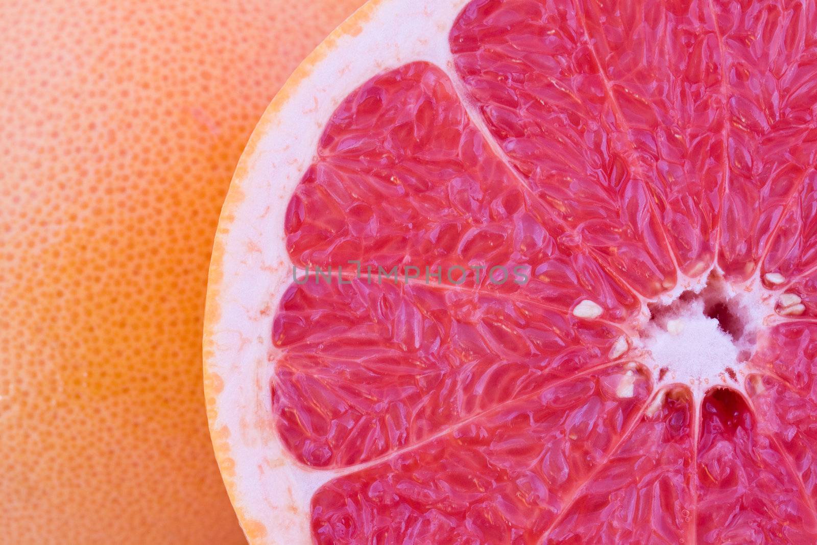 Fresh red grapefruit closeup, natural fruit background