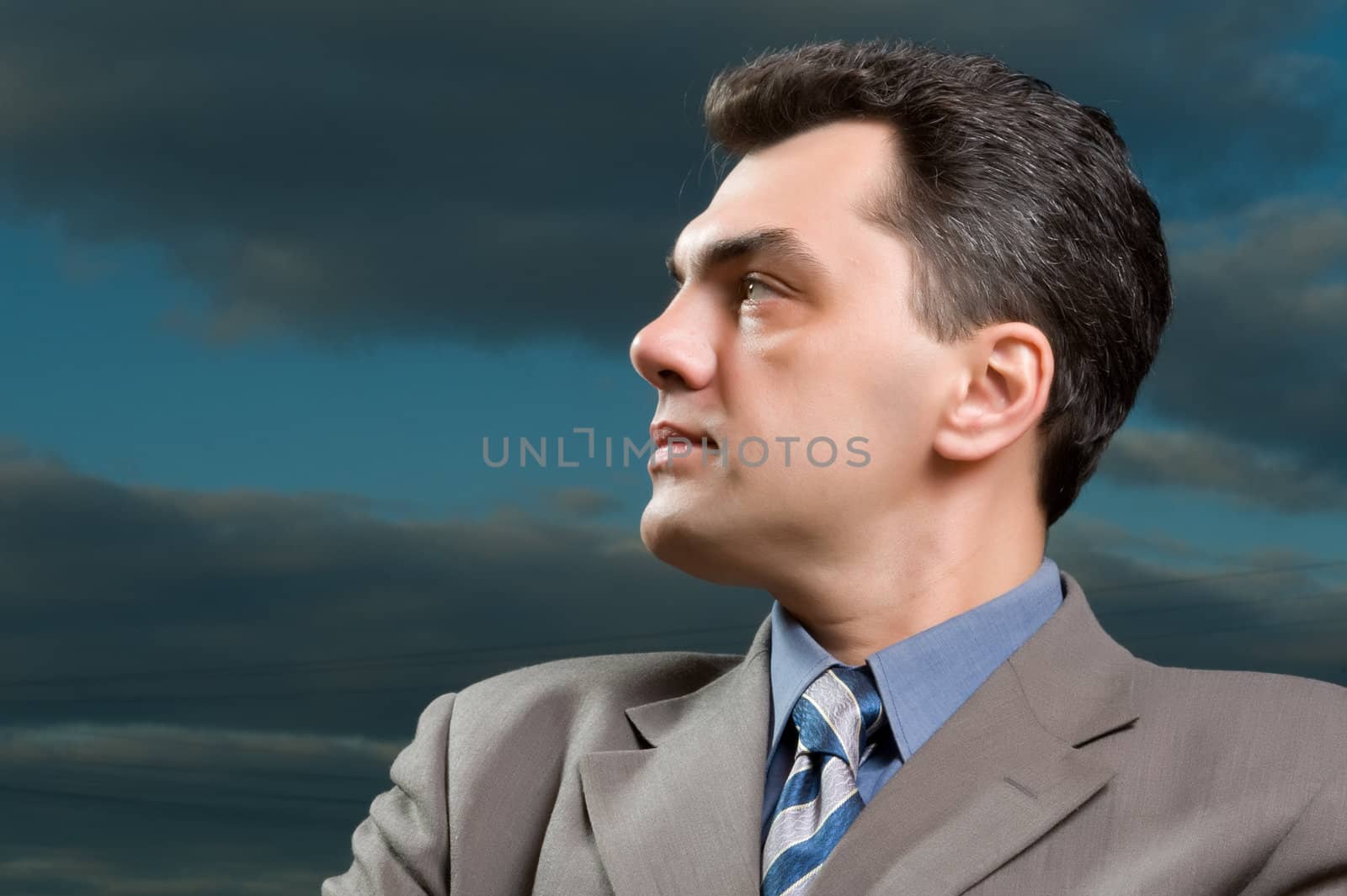 man in a suit against the evening sky