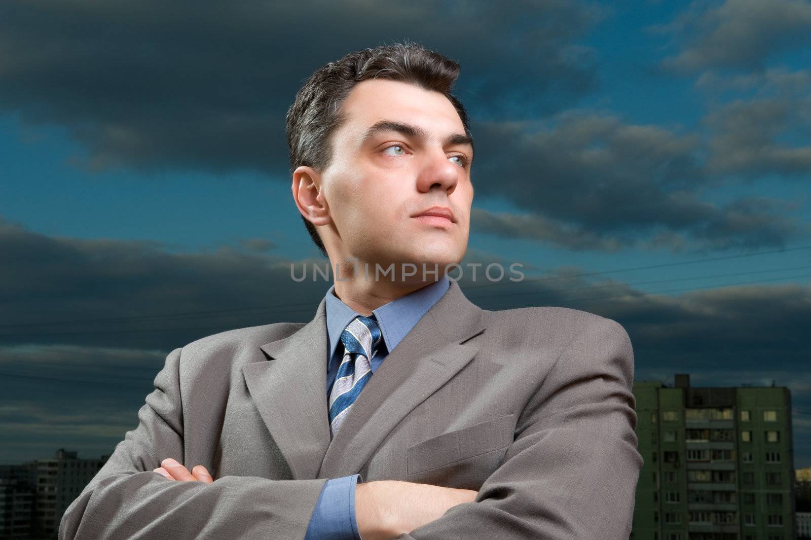 man in a suit against the evening sky