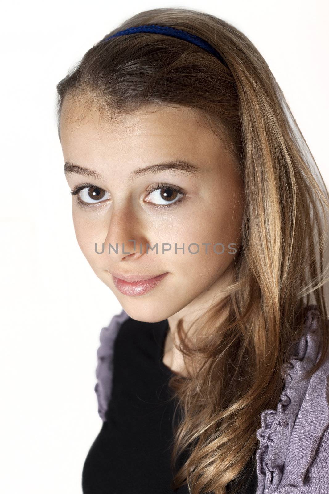 beautiful teenage girl smiling and looking into the camera.  by annems