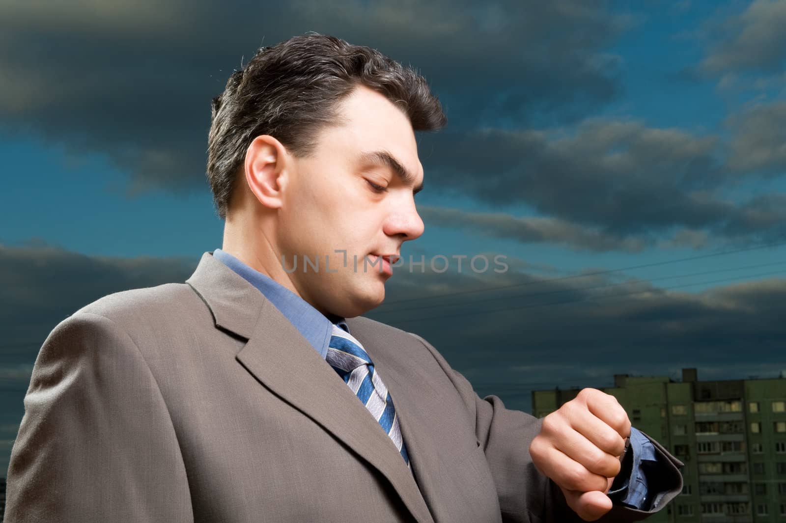 man in a suit against the evening sky