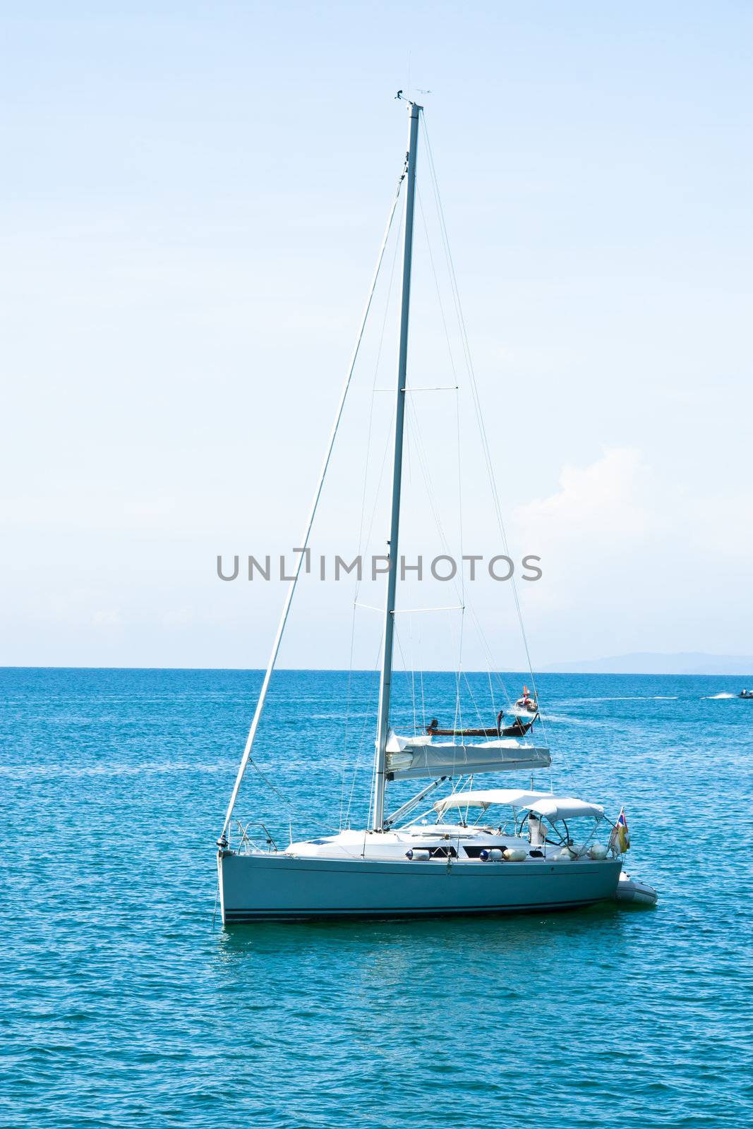 Sailboat in the sea. by Theeraphon