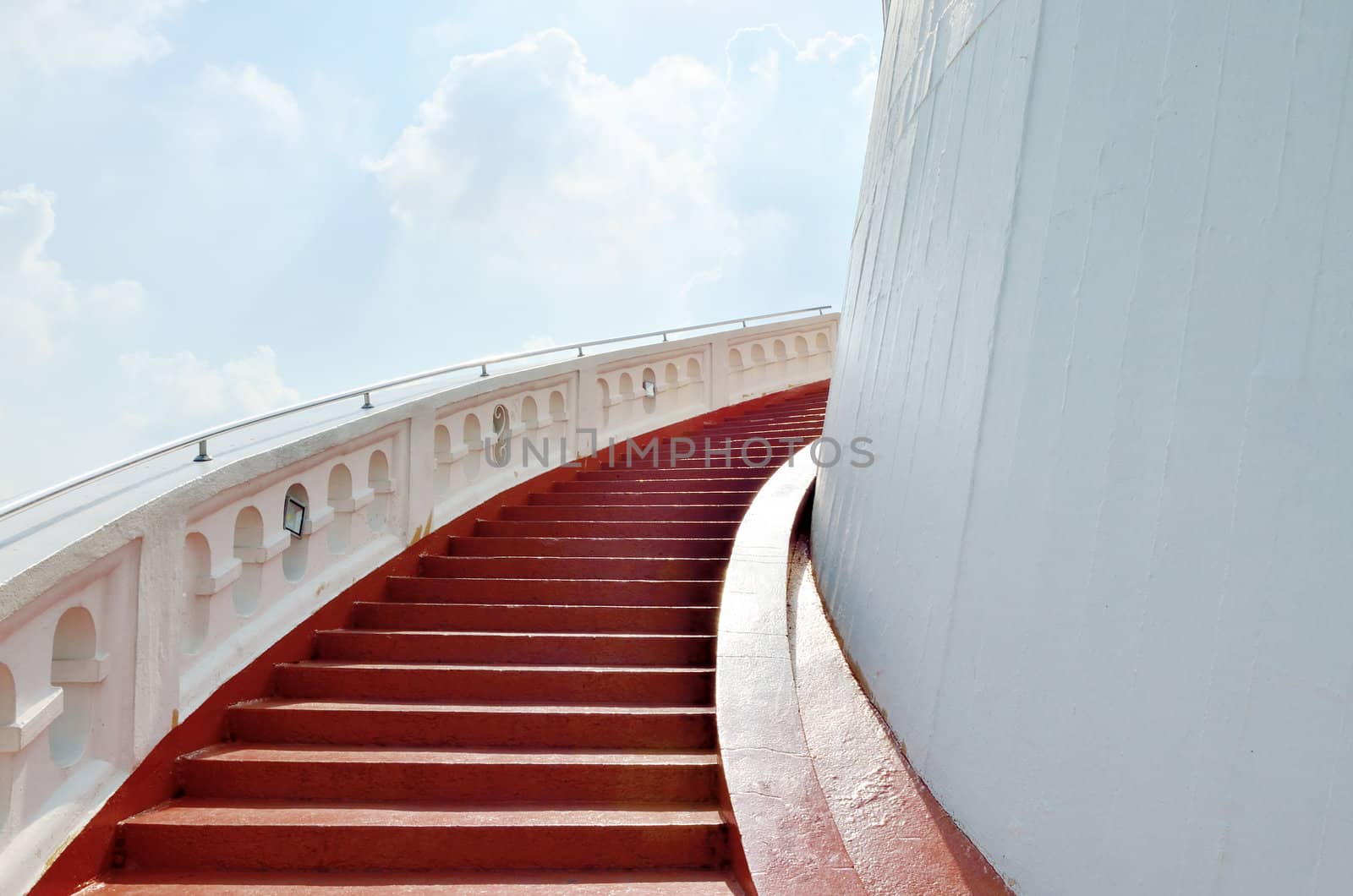 Red stair to the Buddhist temple on hill with cloud background