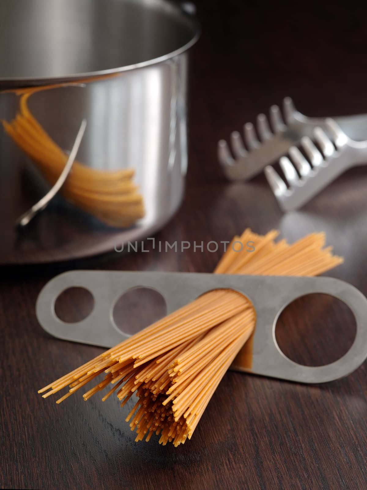 Photo of a portion of spaghetti measured and about to put into a pot for cooking.