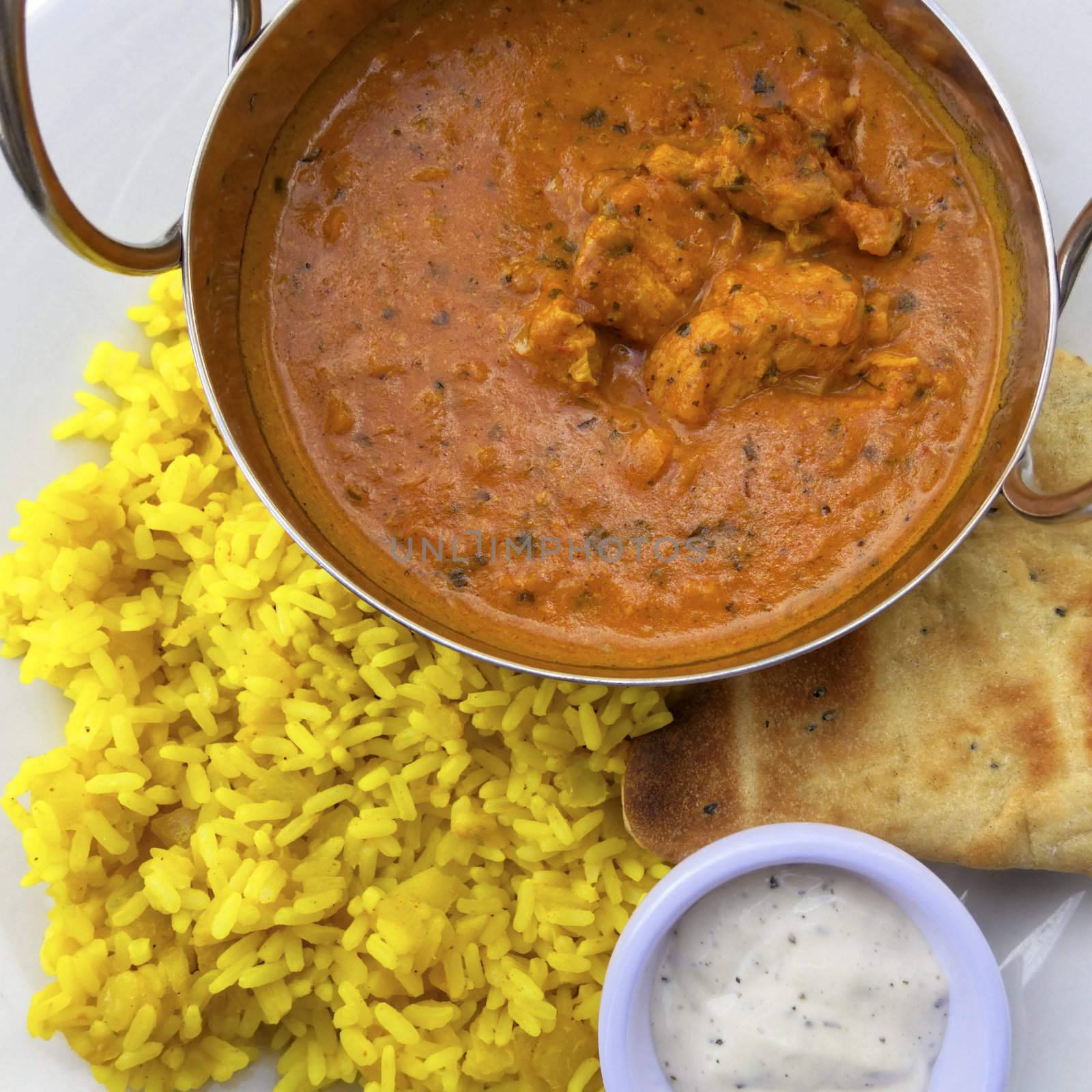 Chicken curry served with rice and naan