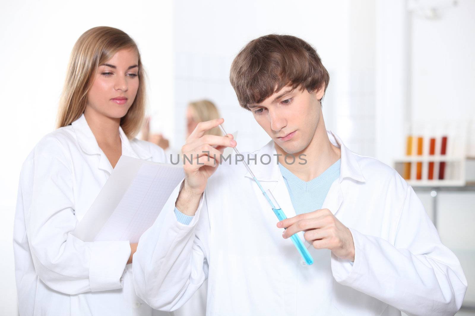 Two science students working in laboratory