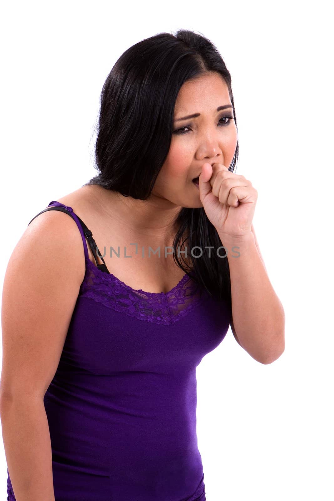 Asian teenager sick with a cold and flu coughs into her fist.