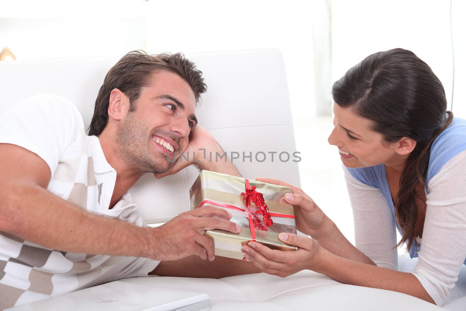Man offering gift to woman by phovoir