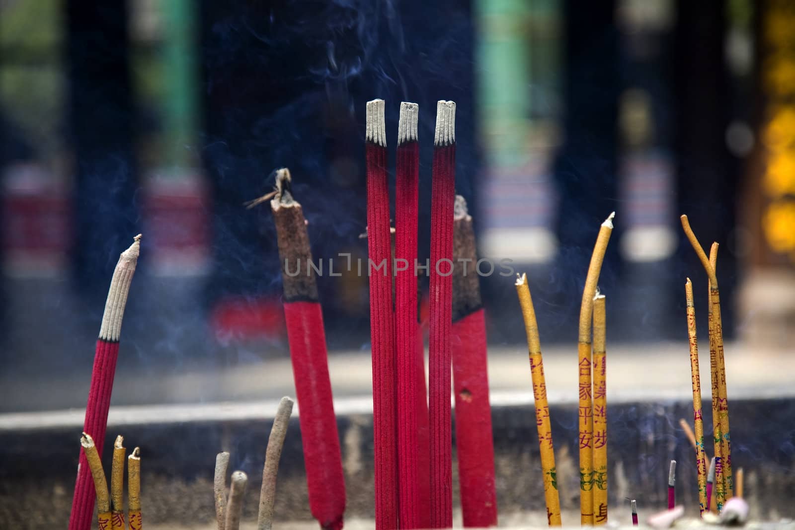 Smoking Incense Sticks Baoguang Si Shining Treasure Buddhist Temple Chengdu Sichuan China Front of Temple 
The Chinese characters on the sticks are not trademarks, but prayerful sayings, such as Peace in the Entire Home.