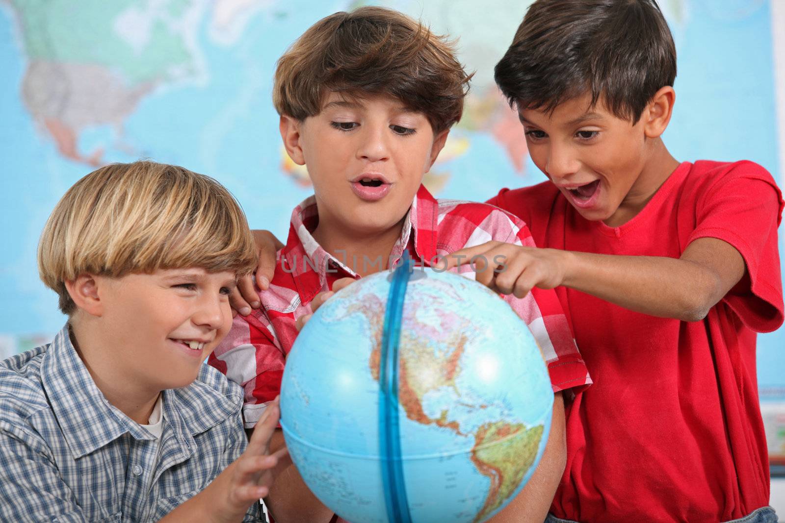 Children looking at a globe by phovoir