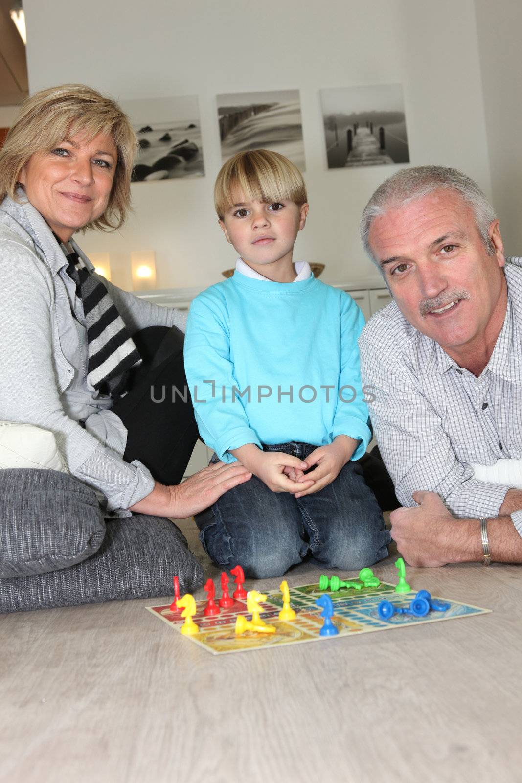 Family playing chess by phovoir