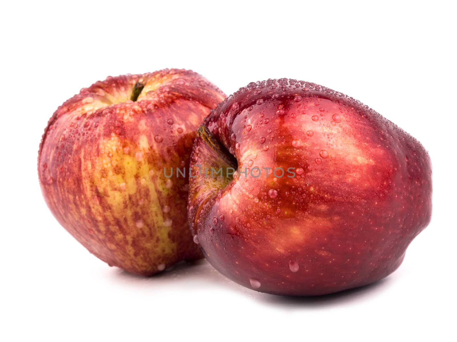 Two tasty red aplles on white background