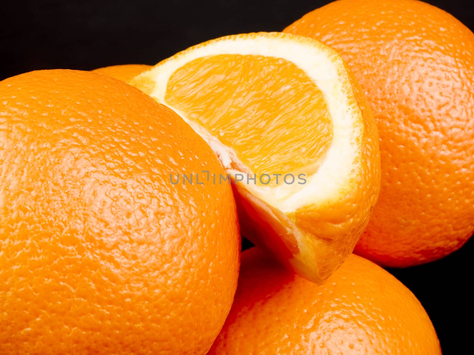 Closeup picture of oranges on black background