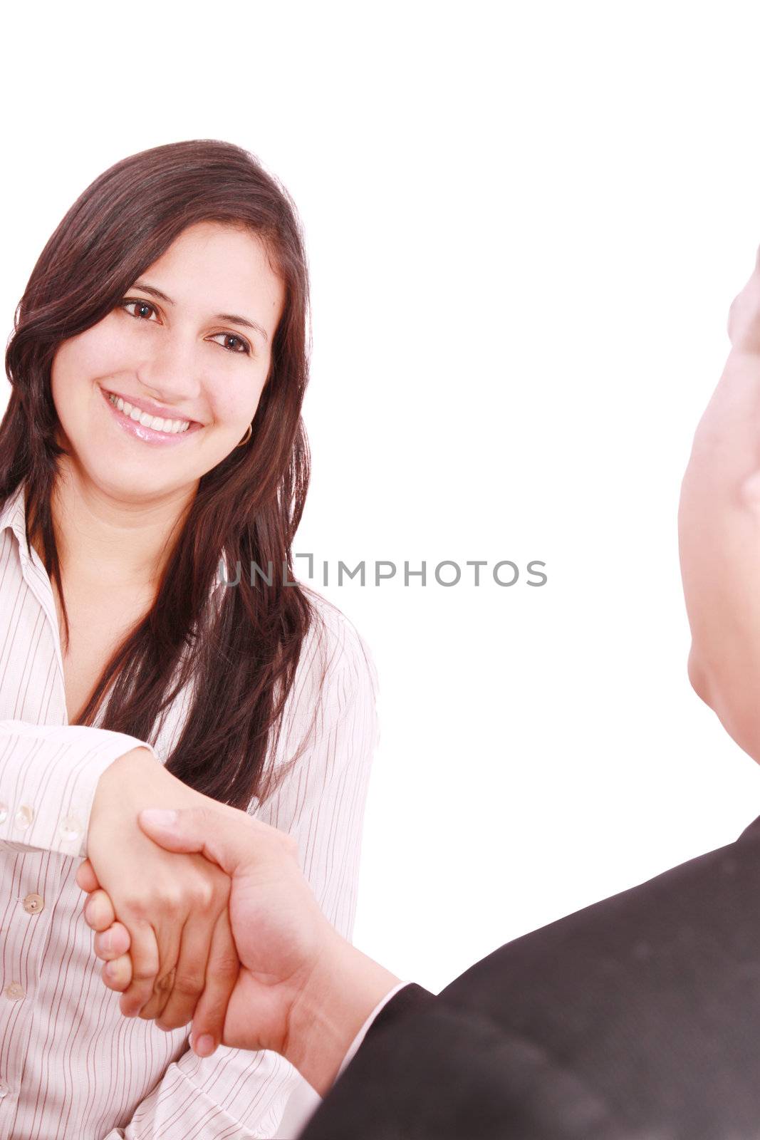 Closeup of business people shaking hands over a deal at office - by dacasdo