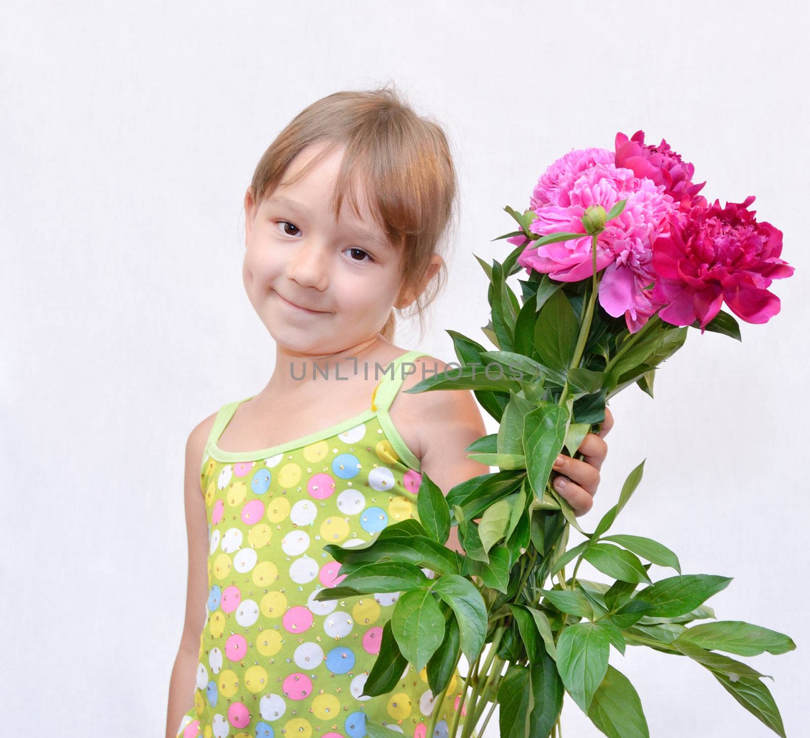 The Child keeps the flowerses, on white background. The Photo.