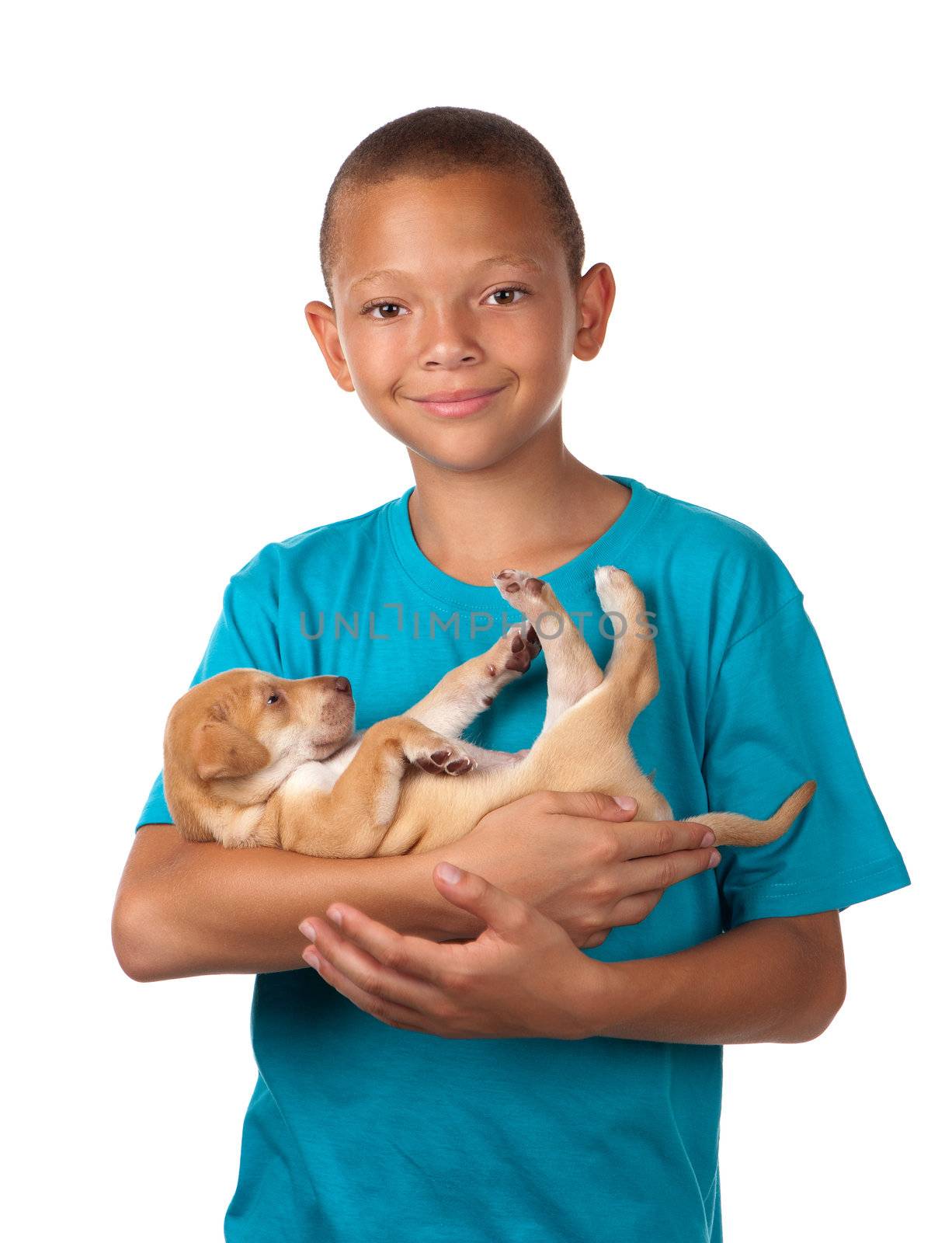 A young boy enjoys holding his puppy dog in his arms.