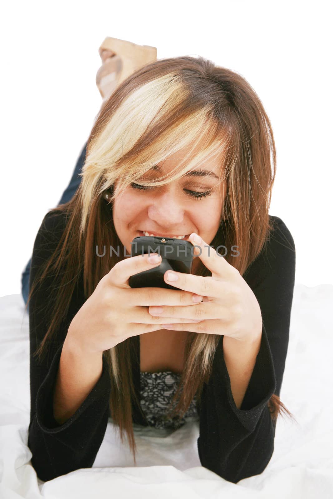 Teenage girl chatting with cell phone lying down - isolate