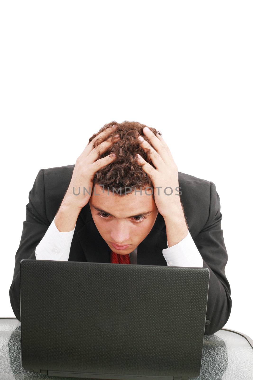 Young caucasian worried businessman with a laptop