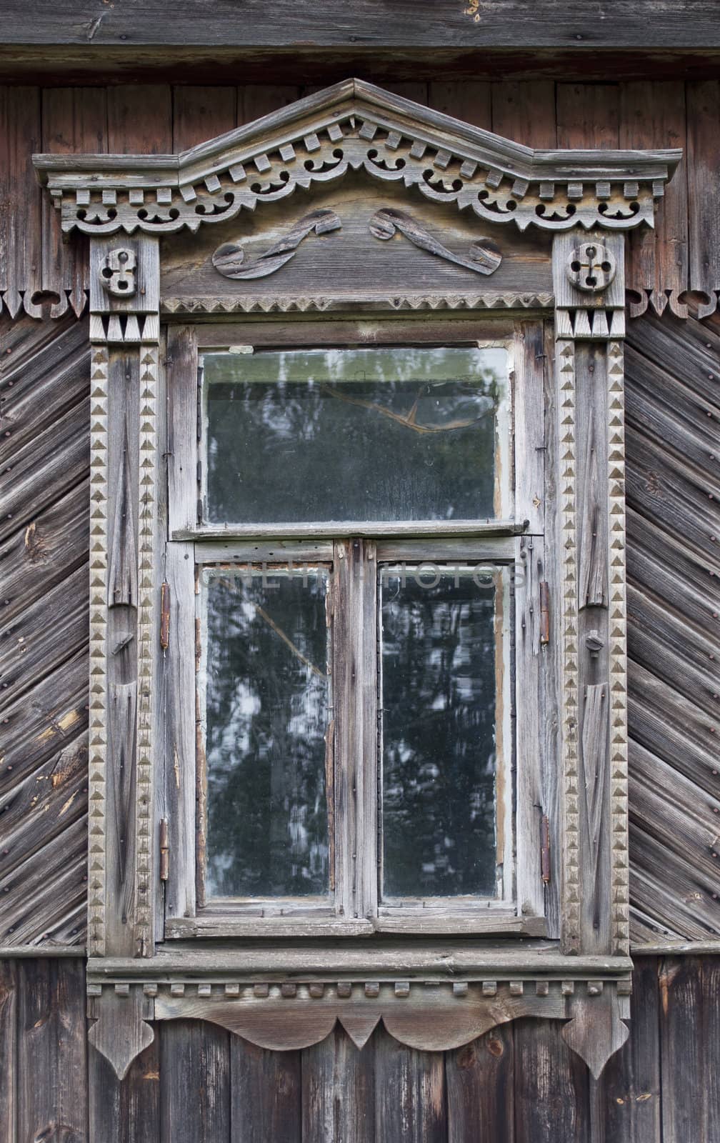 Carved window in old russian wooden country house