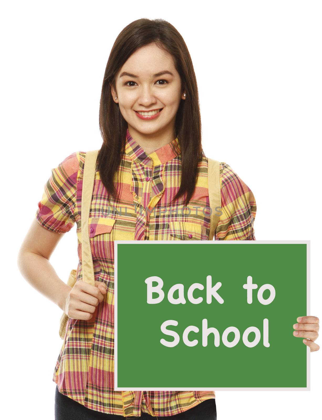 A university student holding a Back To School signboard