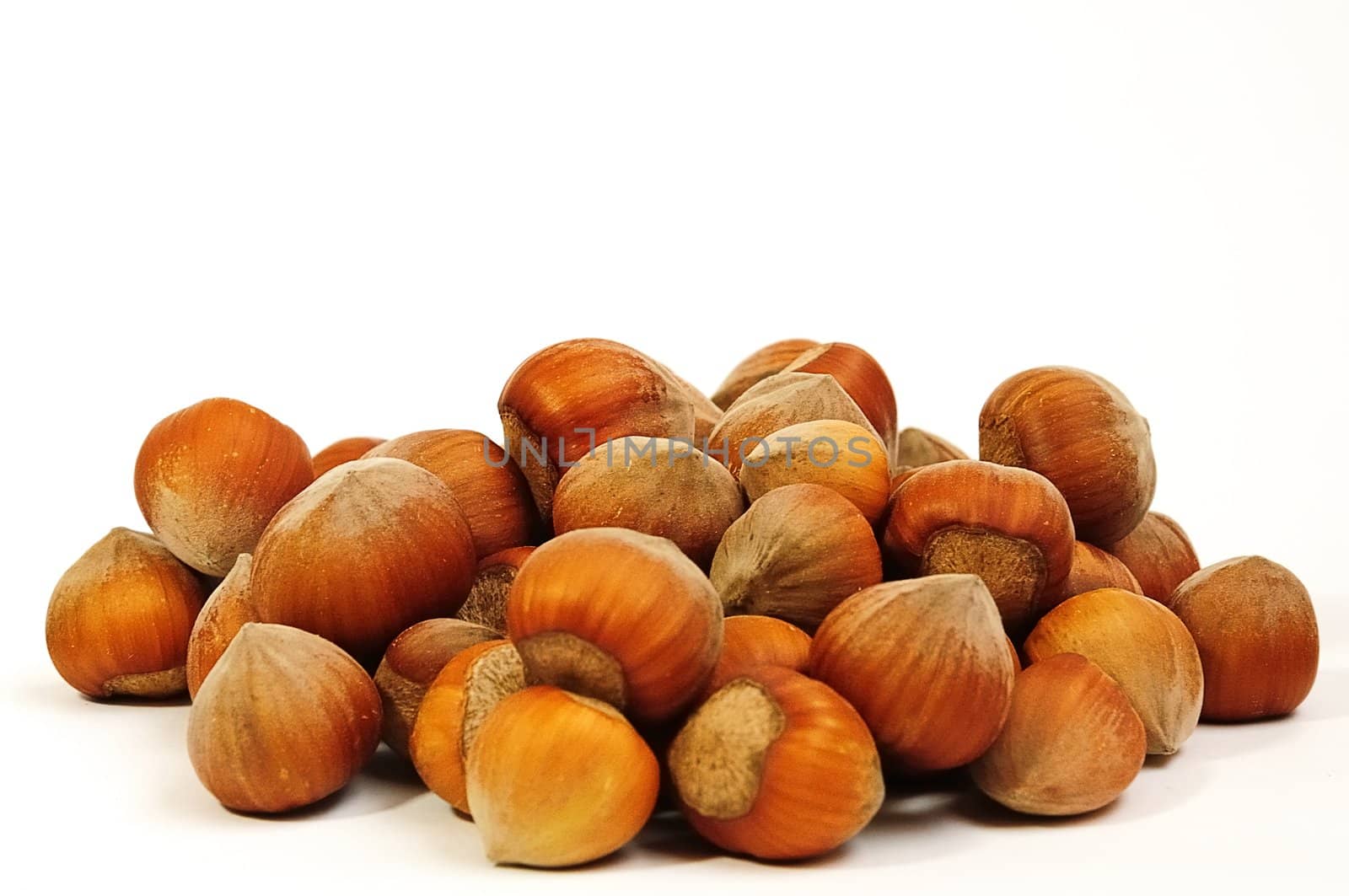 handful of fresh hazelnuts on a white background closeup